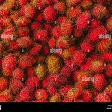 Bright red rambutans with soft spines covering their rinds.