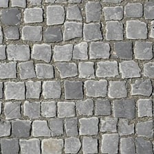 An old street paved with irregular rounded cobblestones.