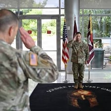 A military officer giving instructions to a group of soldiers