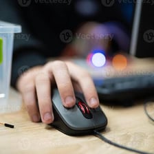 Hand pressing a button on a computer mouse