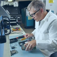 Technicians performing specialized work on equipment