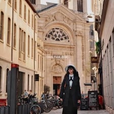 A woman walking on a street in Lyon, France