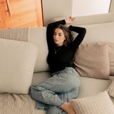 A person relaxing casually on a sofa.