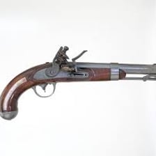 An antique flintlock firearm displayed in a museum
