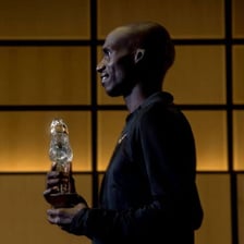 An athlete holding a trophy after setting a record.