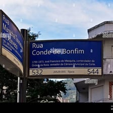 A street scene in Rio de Janeiro showing Portuguese-language signage.