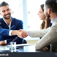 Two people shaking hands to confirm a business agreement