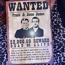 A vintage wanted poster depicting an outlaw