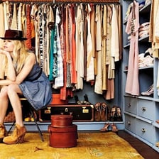 A person choosing a different outfit from a wardrobe.