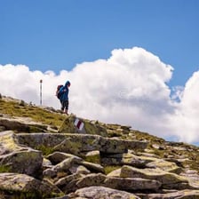A person walking down a steep mountain path.