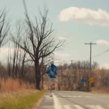 A person running away along a country road