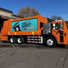 A municipal sanitation truck collecting residential waste bins