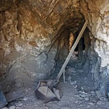 A mine tunnel blocked by a collapse under pressure.
