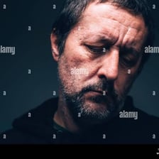 A person visibly distressed and experiencing intense sorrow