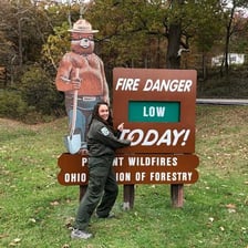 Smokey Bear depicted on a forest-fire-prevention sign.