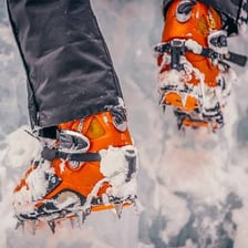 A metal crampon attached to a boot for ice climbing.