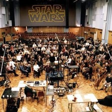 A composer conducting musicians during a film-score recording session.