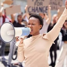 A person speaking forcefully during a protest.