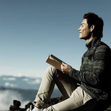 A person reading an inspirational book in a learning setting.