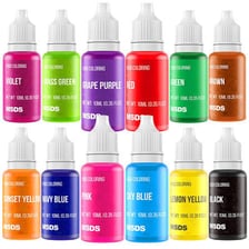 Bottles of food colouring beside icing in several colours