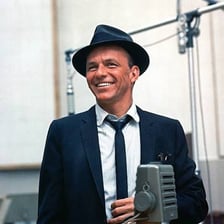 Frank Sinatra wearing a narrow-brimmed trilby hat