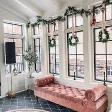 A bright room illuminated by daylight through several windows.
