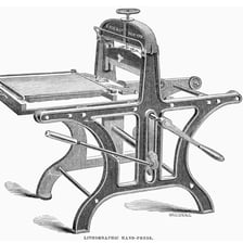 A traditional lithograph print beside a stone lithography press.