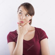 A person concentrating with one hand under the chin.