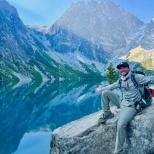 A hiker traveling across a mountain pass.