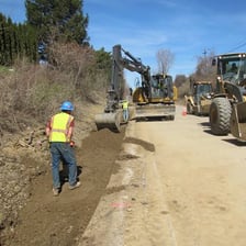 A road construction scene showing a roadway being made wider.