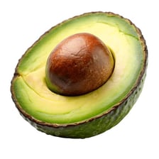 Ripe avocados cut in half, showing their green flesh and brown pits.