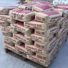 A bag of dry premixed concrete powder used for construction.