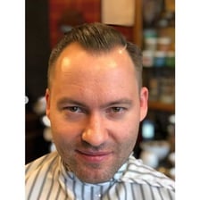 A portrait showing a man with a receding hairline.