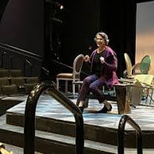 A theater consultant discussing a script with a director and performers.