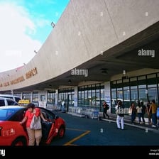 A taxi waiting outside an airport terminal