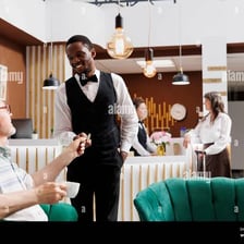 A restaurant waiter receiving a gratuity from a customer
