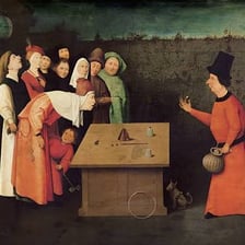 A magician distracting an audience through a deceptive trick.