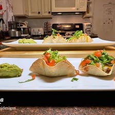 Filled fried corn tortilla shells shaped like small boats.