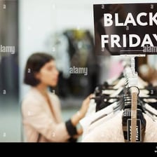 Shoppers browse merchandise in a store during a sale.
