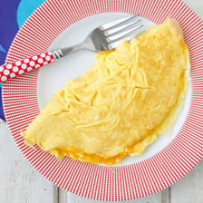 A folded cheese omelette served on a breakfast plate