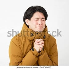 A person clasping their hands while making an earnest plea.