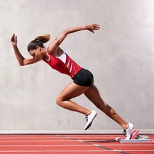 A sprinter moving quickly on a running track