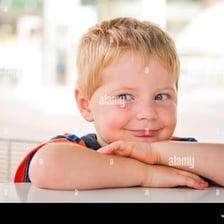 A child displaying a mischievous, cheeky expression.
