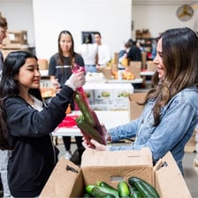 Volunteers handing out food at a community food bank