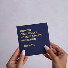 A person holding a written invitation to a social event.
