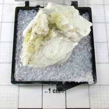 A dark, shiny specimen of natural graphite mineral.