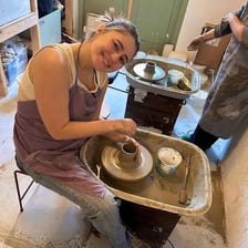 A person casually moving around while doing small household tasks.
