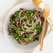 Sliced red radishes served in a green salad