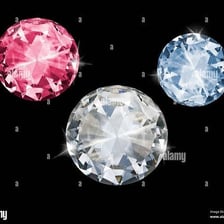 A blue sapphire and a faceted diamond displayed as gemstones.