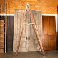A close-up view of the horizontal rungs on a wooden ladder.